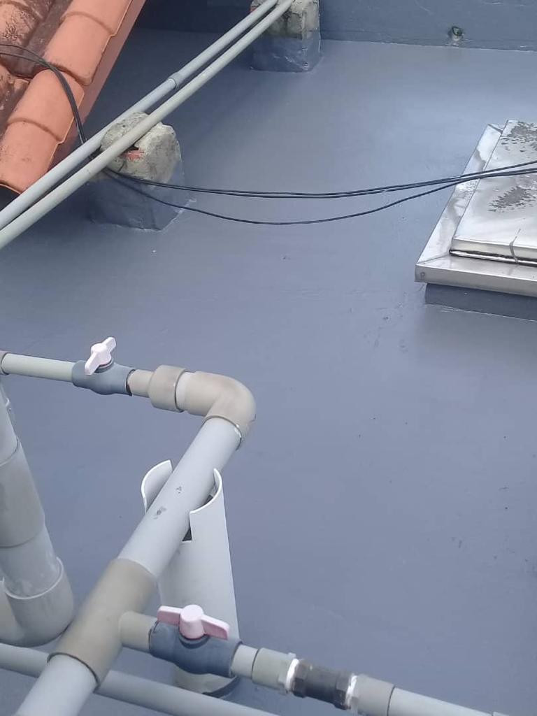 Impian Height · Roof waterproofing · Grey roof coating around existing pipework.